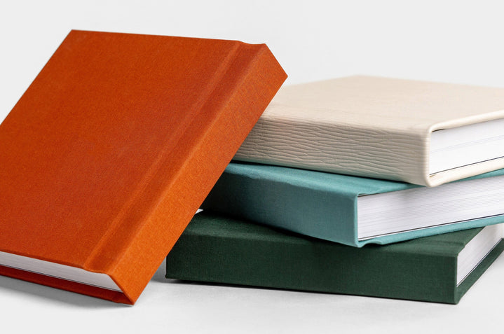 Four 8x8" Album99, covers featured are: Rust Linen, Etched White Leather, Seamist Linen, Evergreen Linen