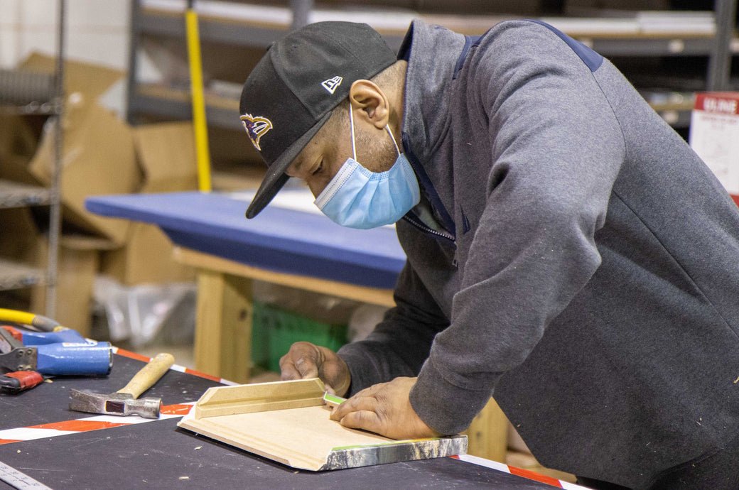 Natoins employee constructing a Premium Canvas Print.