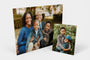 Two Metal Prints standing on a white background, oone 20x30" Metal Print one 8x10" Metal Print, each featuring photos of a family and their two sons. 