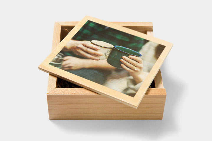 Two people clinking camp mugs on the cover of a custom Wooden USB Box