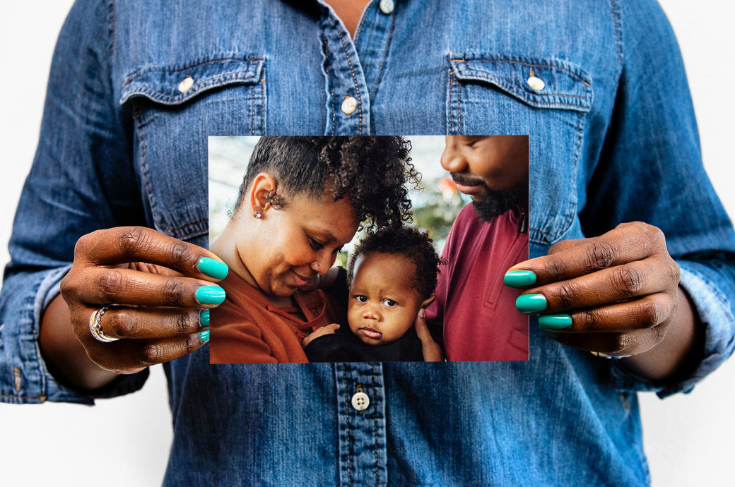 Woman holding a 5x7" Photo Print featuring a picture of a family.