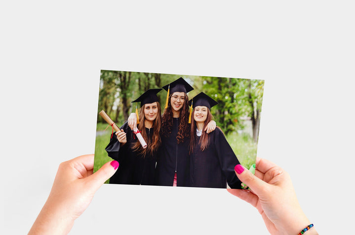 Flat lay of a 7x10" Professional Photo Prints featuring a picture of three recent graduates