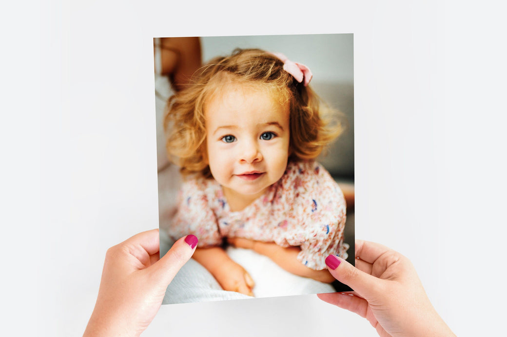 Woman's hands holding a 8x10" Lustre Photo Print featuring a picture of a little girl.