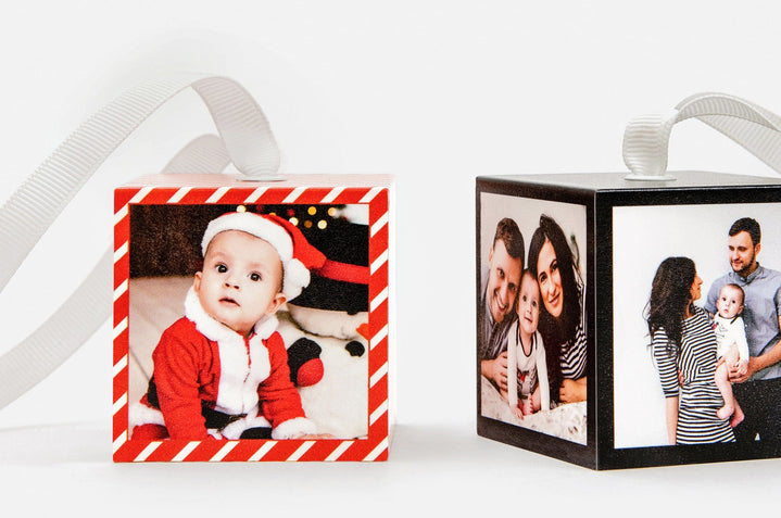 Two Cube Ornaments that feature pictures of a family and their baby