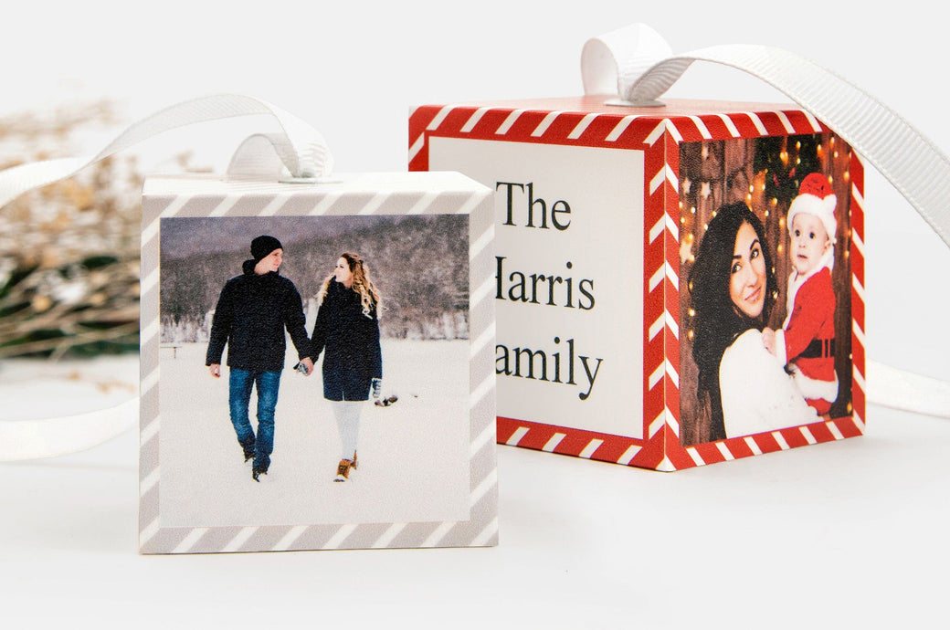 Two Cube Ornaments that feature photos of a couple in the snow and a woman with her baby