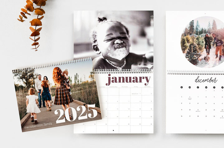 Flat lay of three 8.5x11" Wall Calendars, two Wall Calendars are open to show dates and the third Wall calendar is closed to show the cover design. 